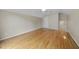 View of empty room with hardwood floors, a door, and a stairway at 207 Ashley Brook Ct, Cary, NC 27513