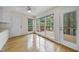 Bright sunroom featuring large windows, hardwood floors, and a door leading to the backyard at 207 Ashley Brook Ct, Cary, NC 27513