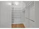 Walk-in closet with custom shelving and clothing racks at 207 Ashley Brook Ct, Cary, NC 27513