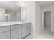 Elegant bathroom featuring double sinks with modern gray cabinets, large mirror, and tiled flooring at 217 Braeburn Dr, Graham, NC 27253