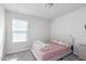 Simple bedroom with a soft pink bedspread and floral quilt, creating a calm and inviting atmosphere at 217 Braeburn Dr, Graham, NC 27253
