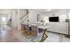 Contemporary dining area features a marble table, modern chairs, and view into the living room at 217 Braeburn Dr, Graham, NC 27253