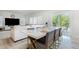 Bright dining area features stylish marble table, seating, and sliding glass doors to backyard patio at 217 Braeburn Dr, Graham, NC 27253