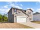 Two-story home features neutral siding, white garage door, red shutters and well maintained lawn at 217 Braeburn Dr, Graham, NC 27253