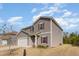 Two-story home with gray siding, white garage door, red shutters and well manicured front yard at 217 Braeburn Dr, Graham, NC 27253