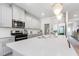 Gourmet kitchen with stainless steel appliances, large island, white cabinets, and subway tile backsplash at 217 Braeburn Dr, Graham, NC 27253