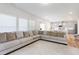 Open floor plan featuring a spacious living area with a large sectional sofa and view of the kitchen at 217 Braeburn Dr, Graham, NC 27253