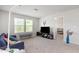 Bright living space features a comfortable sofa, large windows, and neutral carpeting at 217 Braeburn Dr, Graham, NC 27253