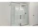 Contemporary bathroom shower with glass doors, multiple shower heads and built-in shelves for convenient storage at 217 Braeburn Dr, Graham, NC 27253