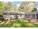 Backyard view showcasing a blend of lush greenery, mature trees, and patio area at 2225 Whitley Dr, Durham, NC 27707