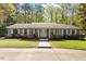 Charming single-story home boasts a well-maintained lawn, mature trees, and inviting front porch at 2225 Whitley Dr, Durham, NC 27707