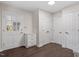 Hallway with hardwood flooring, white trim, and multiple access doors for privacy and convenience at 2225 Whitley Dr, Durham, NC 27707