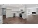 Bright white kitchen features stainless steel appliances and hardwood floors at 2225 Whitley Dr, Durham, NC 27707