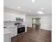 White kitchen boasts modern stainless appliances and a skylight for natural lighting at 2225 Whitley Dr, Durham, NC 27707