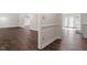 Open living space features hardwood floors, neutral walls, and natural light flowing through French doors at 2225 Whitley Dr, Durham, NC 27707