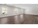 Bright living room features hardwood floors, neutral walls, and a chandelier providing warm light at 2225 Whitley Dr, Durham, NC 27707