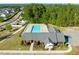Aerial view of the community pool, clubhouse, and surrounding neighborhood at 226 Marquis Dr, Cameron, NC 28326