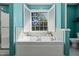 Bathroom with soaking tub, tile surround, and natural light from shuttered window at 226 Marquis Dr, Cameron, NC 28326