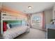 Cozy bedroom features a bunk bed and a large window with pink curtains, offering a bright and inviting space at 226 Marquis Dr, Cameron, NC 28326