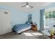 Bright bedroom with a blue and white color scheme, featuring a twin bed, a window, and a comfortable chair at 226 Marquis Dr, Cameron, NC 28326