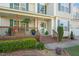 Charming two-story home featuring a covered porch with brick accents, green shutters, and landscaped front yard at 226 Marquis Dr, Cameron, NC 28326