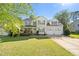 Charming two-story home featuring a landscaped yard, front porch, and two-car garage at 226 Marquis Dr, Cameron, NC 28326