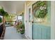 Inviting covered porch with a wreath on the front door and a wooden bench at 226 Marquis Dr, Cameron, NC 28326