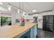Open kitchen with island, modern lighting, stainless appliances, and white cabinets at 226 Marquis Dr, Cameron, NC 28326