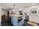 Bright kitchen featuring a blue island with butcher block countertop, stainless steel appliances, and sleek black tile floors at 226 Marquis Dr, Cameron, NC 28326