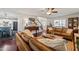 Open-concept living room showcasing hardwood floors, stylish furniture, and seamless flow to the kitchen and entry at 226 Marquis Dr, Cameron, NC 28326