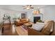 Inviting living room with hardwood floors, comfortable leather seating, a fireplace, and natural light from the window at 226 Marquis Dr, Cameron, NC 28326