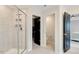Modern bathroom featuring a glass-enclosed shower, sleek hardware, and an adjacent walk-in closet at 2283 Grants Pass Sta, Apex, NC 27502