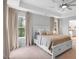 Bright bedroom with neutral walls, carpet, large windows, and ensuite access to the bathroom at 2283 Grants Pass Sta, Apex, NC 27502