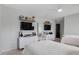 Bedroom featuring two white-framed beds, wall-mounted televisions, and modern white dressers, ideal for a comfortable and tech-friendly space at 2283 Grants Pass Sta, Apex, NC 27502