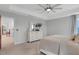 Bright bedroom with a ceiling fan, plush carpet, and ensuite bathroom access at 2283 Grants Pass Sta, Apex, NC 27502
