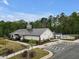 Community clubhouse with a modern design, surrounded by lush landscaping, a pool, and convenient parking at 2283 Grants Pass Sta, Apex, NC 27502