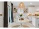 Bright dining area features a round table, stylish lighting fixture, and comfortable seating with natural light from sliding glass doors at 2283 Grants Pass Sta, Apex, NC 27502