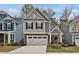 Charming two-story home with stone accents, neutral siding, attached garage, and well-manicured lawn at 2283 Grants Pass Sta, Apex, NC 27502
