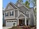 Charming two-story home with stone accents, neutral siding, attached garage, and covered front porch at 2283 Grants Pass Sta, Apex, NC 27502