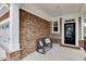 Cozy front porch with stone accent wall and a bench at 2283 Grants Pass Sta, Apex, NC 27502