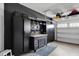 Organized garage with storage cabinets, a workbench, and overhead shelving, providing ample space for tools and equipment at 2283 Grants Pass Sta, Apex, NC 27502