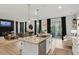 Wide angle of the open-concept kitchen with granite countertops, a large center island, and seamless connection to the living and dining areas at 2283 Grants Pass Sta, Apex, NC 27502