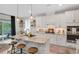 Open-concept kitchen features a large center island, stainless steel appliances, and seamless connection to the dining and outdoor living areas at 2283 Grants Pass Sta, Apex, NC 27502