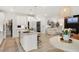 Open-concept kitchen with an island is next to the living and dining areas, creating an inviting and connected living space at 2283 Grants Pass Sta, Apex, NC 27502