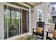 Covered patio with comfortable seating, outdoor views, and seamless access to the interior living spaces through sliding glass doors at 2283 Grants Pass Sta, Apex, NC 27502