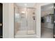 New shower with a glass door, tile surround, and modern fixtures leading into the walk-in closet at 2283 Grants Pass Sta, Apex, NC 27502