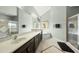 Well-lit bathroom featuring double sinks, a soaking tub, and a separate walk-in shower at 233 Pointe Park Cir, Holly Springs, NC 27540