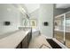 Spacious bathroom featuring a double vanity, soaking tub, and glass enclosed shower at 233 Pointe Park Cir, Holly Springs, NC 27540