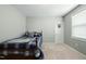Neutral bedroom features carpet, a window, and bed with gray and blue linens at 233 Pointe Park Cir, Holly Springs, NC 27540