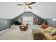 Comfortable bonus room with a seating area, built-in shelves, and a large window with natural light at 233 Pointe Park Cir, Holly Springs, NC 27540